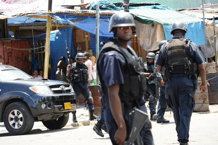 Jamaica Attacks: Police patrol on May 24 in Kingston, Jamaica, after two police officers were killed after coming under attack amid spreading unrest. A state of emergency was declared by the Prime Minister. (Anthony Foster/AFP/Getty Images)