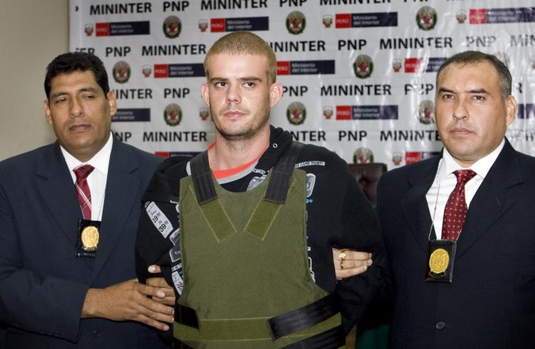 Joran van der Sloot is escorted by Peruvian police in Peru on June 5. Van der sloot is now suing the public defender who represented him when Sloot confessed to the killing of Stephany Flores. (Marcel Antonisse/Getty Images)