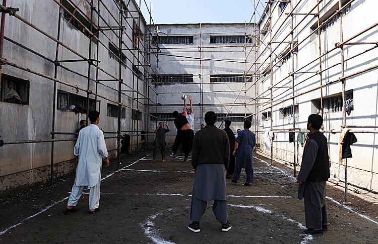 SHOT OF THE PRISON: In this March 7, 2010 photograph, Afghan prisoners show their volleyball skills to local and international media at Pul-e Charkhi prison. (Massoud Hossaini/AFP/Getty Images)