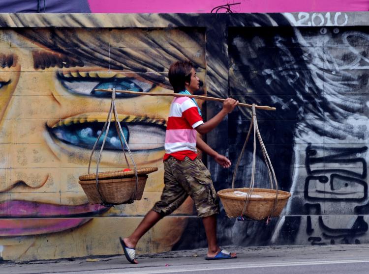 A Thai walking the backstreets of Bangkok. (Pornchai Kittiwongsakul/AFP/Getty Images)