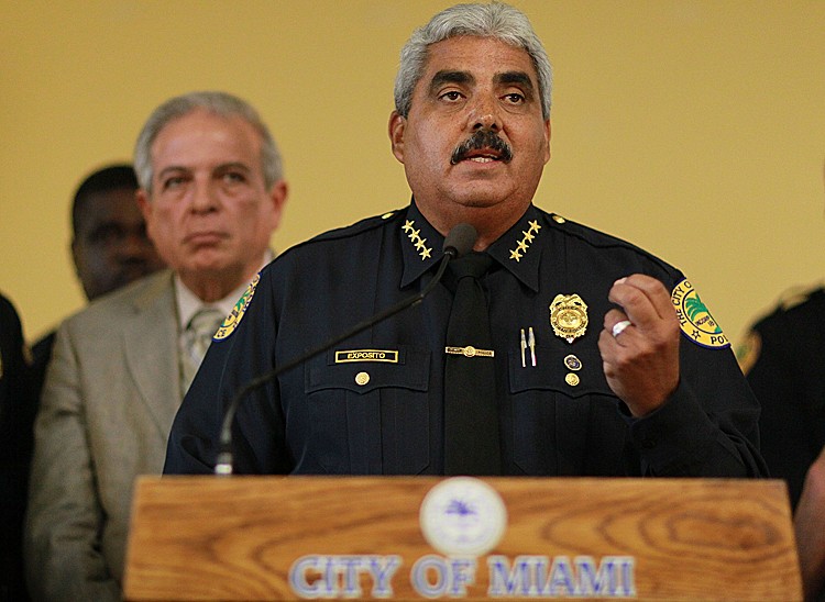 City of Miami Mayor Tomas Regalado (L) listens as police Chief Miguel A. Exposito speaks during a press conference on August 10, 2010 in Miami, Florida. (Joe Raedle/Getty Images)