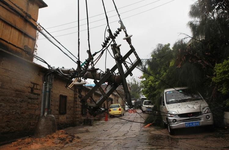 A fallen electric pole lies across a street in Xiamen, southeast China's Fujian province, on September 20. China warned of flash floods and landslides as Typhoon Fanapi made landfall on the mainland, one day after slamming Taiwan with heavy rains, which left more than 100 injured on the island. (STR/Getty Images)