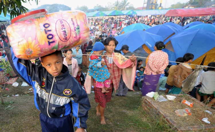 A boy carries a bag as Myanmar refugees arrived in a temporary camp set up at a police base on the border town of Mae Sot on November 9, 2010. (PORNCHAI KITTIWONGSAKUL/AFP/Getty Images)