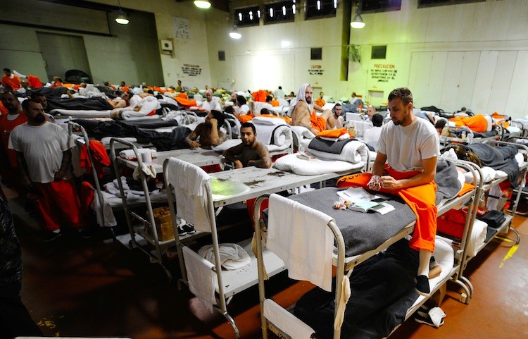 Inmates at Chino State Prison, which houses 5500 inmates, crowd around double and triple bunk beds at a gymnasium that was modified to house 213 prisoners on December 10, 2010 in Chino, California. (Kevork Djansezian/Getty Images)