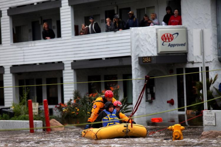 Danielle Broadnex, who is pregnant, is rescued from floodwaters after being stranded in a hotel, after a powerful rainstorm Dec. 22, 2010 in San Diego, California.  (Sandy Huffaker/Getty Images)