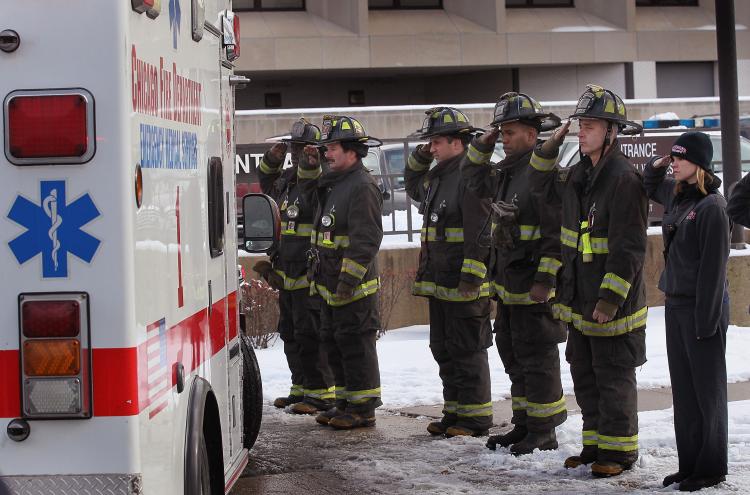 Chicago Fire Department: Firefighters salute as an ambulance carrying the remains of a fellow firefighter arrives at the Medical Examiners office Dec. 22 in Chicago, Illinois. (Scott Olson/Getty Images)