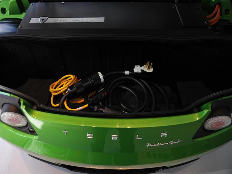 TESLA: A charging cable is seen in the trunk of a Tesla Roadster Sport Feb. 10 during the launch of the new Tesla showroom in Washington, DC. Tesla shares soared after an analyst upgrade on Thursday. (Mandel Ngan/AFP/Getty Images)