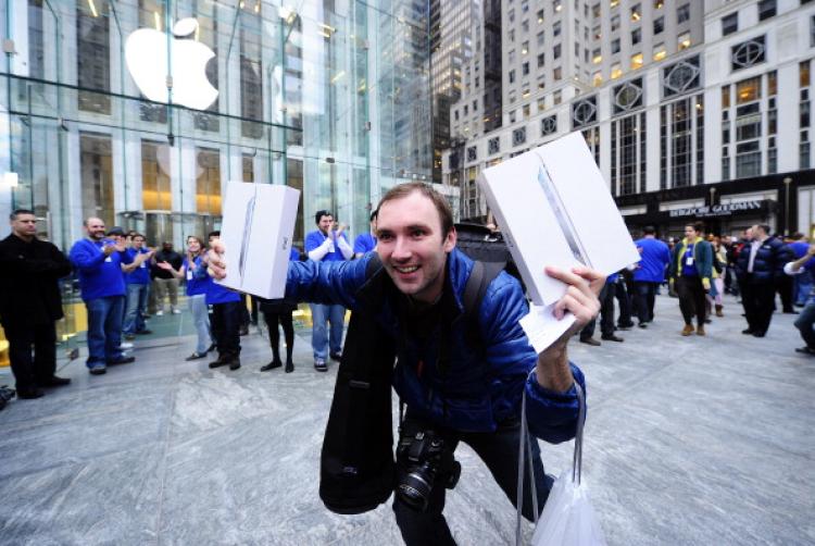 A man celebrates after being the first customer to buy the latest Ipad 2 at the Apple store on in New York on March 11, 2011. (Emmanuel Dunad/AFP/Getty Images)