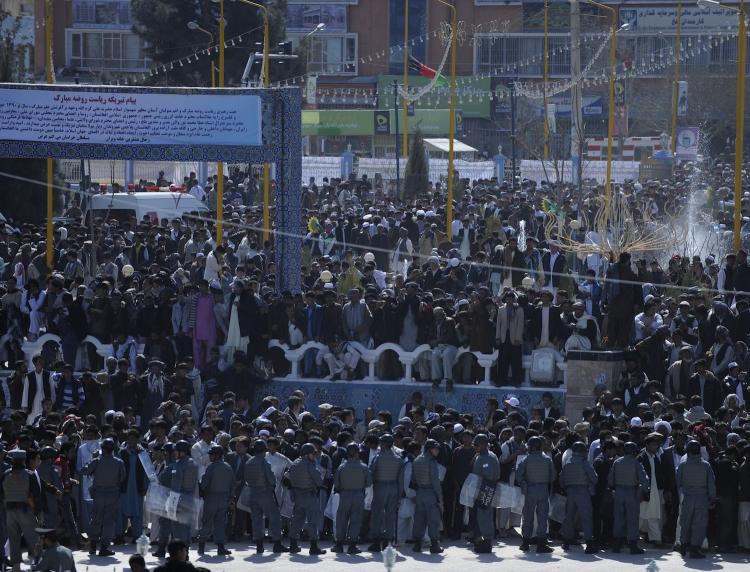 Afghan men gather as they attend the center of Afghan New Year 'Nowruz' celebrations north of Afghanistan on March 21. Police and military were on high alert ahead of a planned new year announcement by President Hamid Karzai of plans for a gradual transfer of responsibilities from foreign troops to Afghan security forces. (Massoud Hossaini/Getty Images )