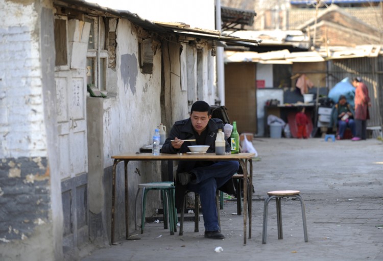 A man has his lunch at a noodle restaurant in Beijing on April 11. Satisfaction with life for ordinary Chinese has not grown as fast as the economy over the past 30 years. (Liu Jin/AFP/Getty Images)