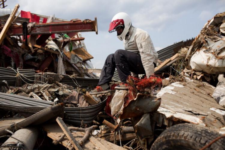 A Japanese man finds his friend's car in the tsunami debris in Rikuzentakata, Iwate prefecture, on April 2, 2011. (Yashuyoshi Chiba/AFP/Getty Images)