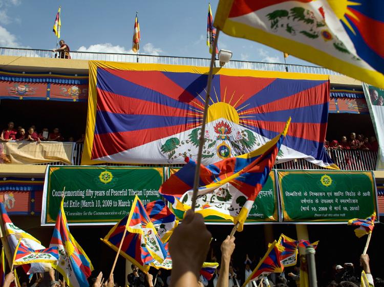 Tibetans in exile wave flags during a ceremony to commemorate 50 years in exile on March 10, 2009 in Dharamsala, India.    (Daniel Berehulak/Getty Images)