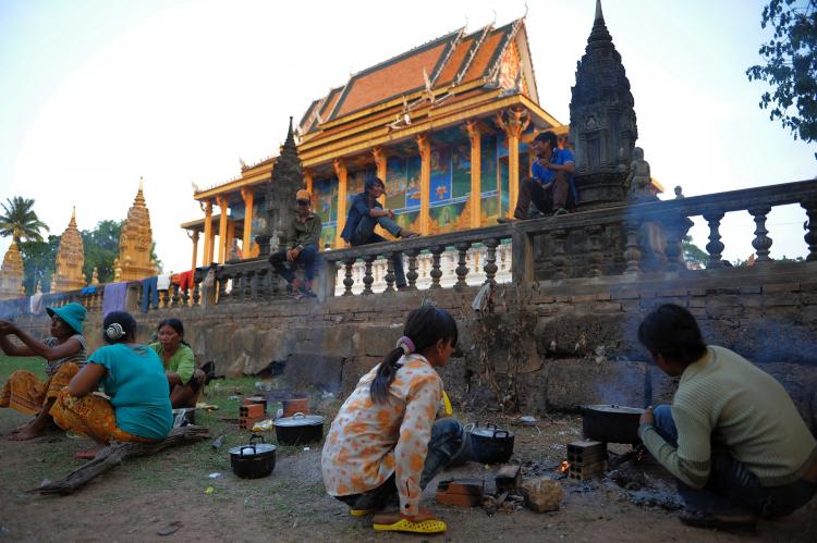 CAUGHT IN THE MIDDLE: Cambodians who live near the Thai-Cambodia border cook at a pagoda after being evacuated due to cross-border fighting on April 24. (Tang Chhin Sothy/Getty Images )