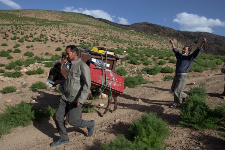 Dr. Jaghori (R) rejoices reaching the top of the mountain pass after a long day at a mobile health clinic June 9, 2011. (Paula Bronstein/Getty Images)