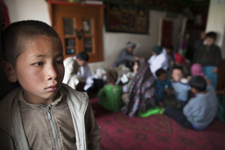 A boy waits for his family to be seen by the doctor at a mosque, makeshift mobile health clinic June 12, 2011. (Paula Bronstein/Getty Images)