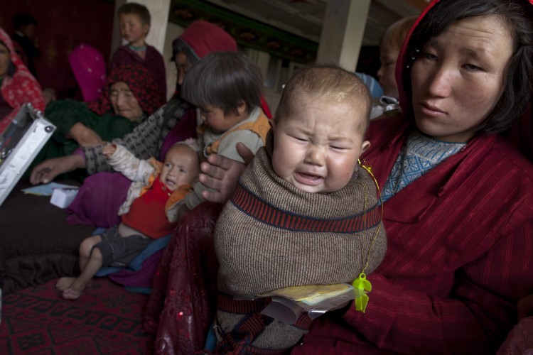 Villagers wait for medical treatment in a makeshift mobile health clinic June 12, 2011. (Paula Bronstein/Getty Images)