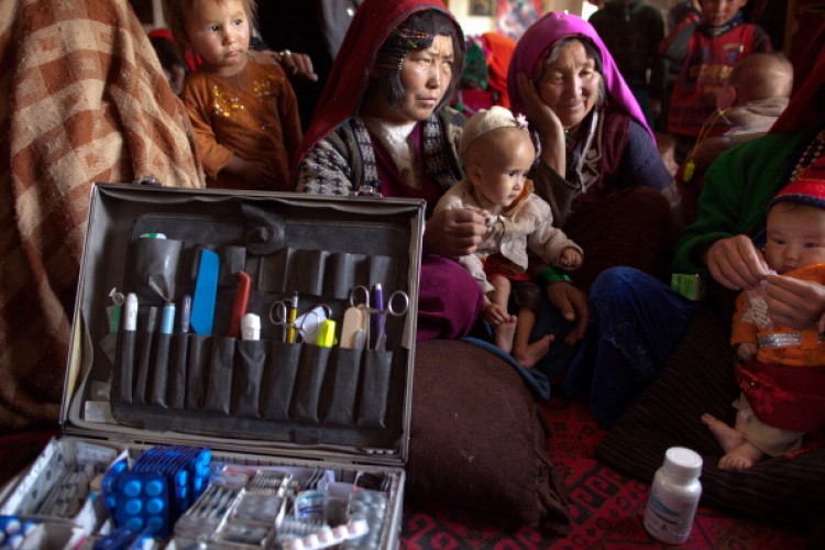 Rashidi deals with a long line of patients at a mosque, makeshift mobile health clinic June 12, 2011. (Paula Bronstein/Getty Images)