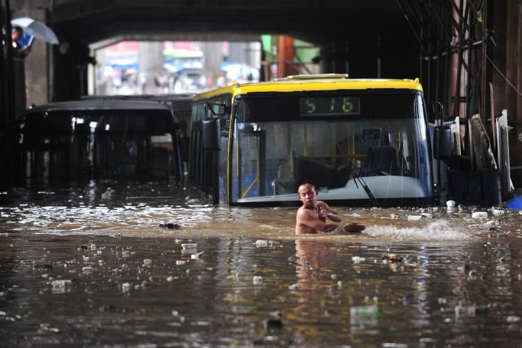 Vehicles are trapped in a flooded street after heavy rainfall on June 18, 2011 in Wuhan, Hubei Province of China. (ChinaFotoPress/Getty Images)