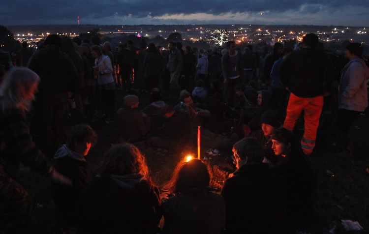 Festival goers gather around a fire at the Stone Circle at the Glastonbury Festival site. (Matt Cardy/Getty Images)