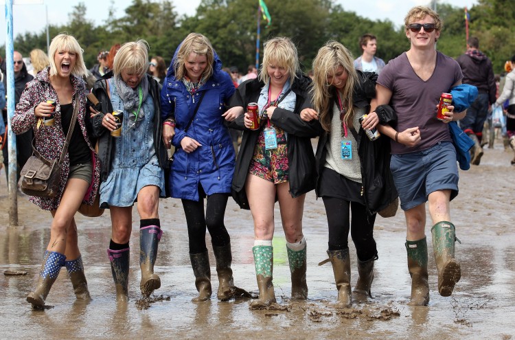 People make their way through the mud at the Glastonbury Festival site at Worthy Farm, Pilton on June 23, 2011 in Glastonbury. (Matt Cardy/Getty Images)