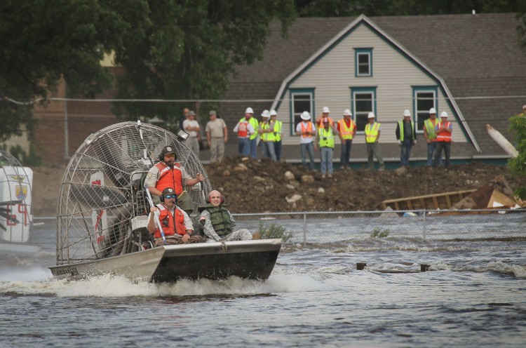 Emergency response workers navigate floodwater from the Souris River on June 25, 2011 in Minot, North Dakota. (Scott Olson/Getty Images)