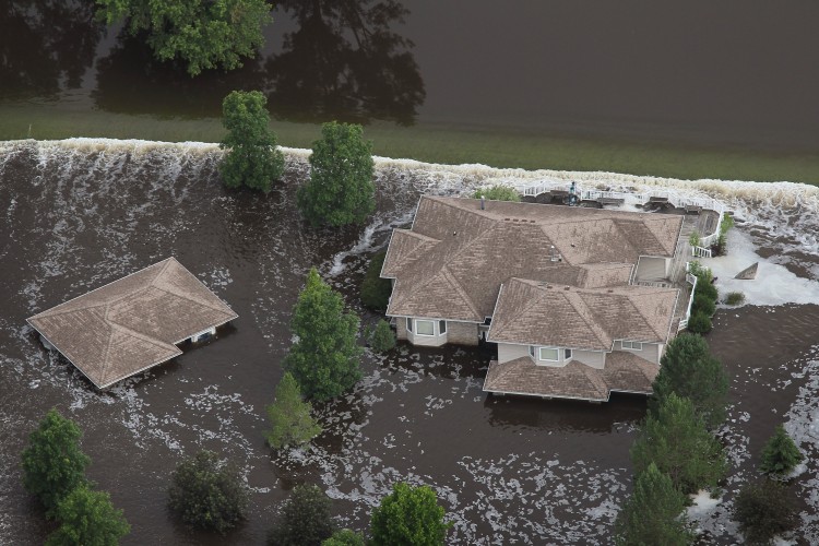 Homes are surrounded by floodwater as the Souris River crests as seen from the air June 26, 2011 in Minot, North Dakota. (Scott Olson/Getty Images)