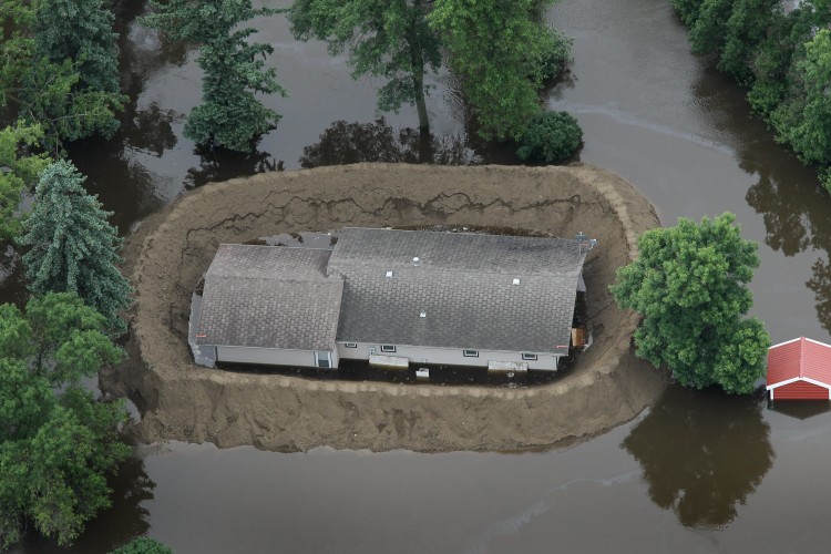 A home is surrounded by floodwater as the Souris River crests as seen from the air June 26, 2011 in Minot, North Dakota. (Scott Olson/Getty Images)