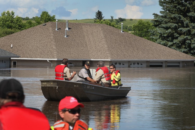 Emergency workers head out to survey flood damage June 26, 2011 in Burlington, North Dakota. (Scott Olson/Getty Images)