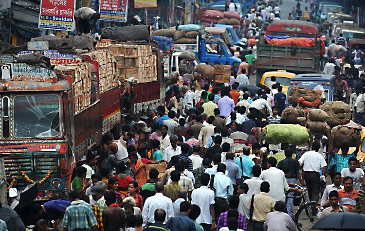 Indian commuters travel along a congested street of Calcutta July 11, on World Population Day. (Dibyangshu Sarkar/AFP/Getty Images)