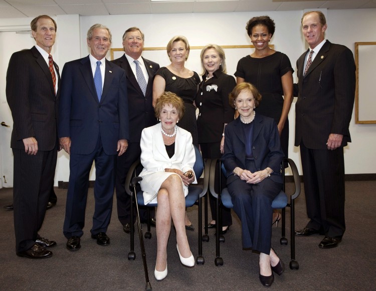 GROUNDBREAKER: Mike Ford, former President George W. Bush, Jack Ford, Susan Ford Bales, former first lady and Secretary of State Hillary Rodham Clinton, first lady Michelle Obama, and Steve Ford stand as former first lady Nancy Reagan and former first lady Rosalynn Carter sit before the funeral of trailblazing first lady Betty Ford at St. Margaret's Episcopal Church July 12 in Palm Desert, Calif. (David Hume Kennerly/Getty Images )