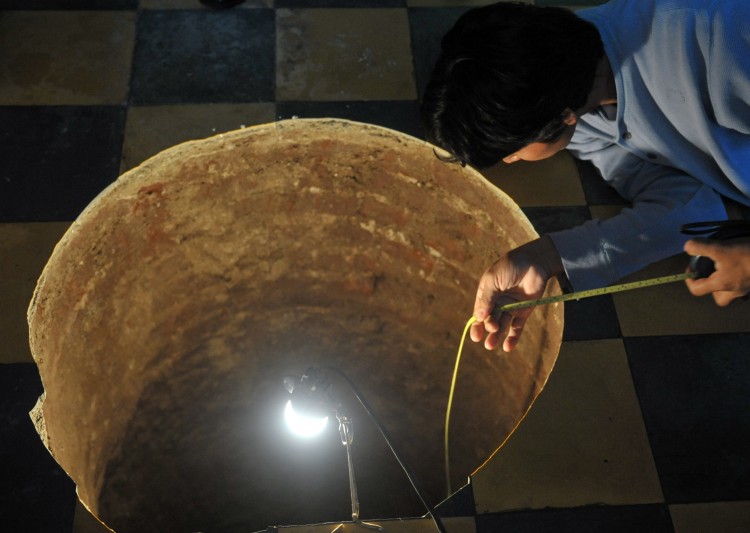 ALMOST PERFECTLY ROUND: A man inspects the Guatemala City sinkhole inside a house on July 19. (Johan Ordonez/AFP/Getty Images)