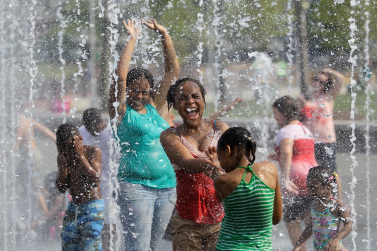 A mother cools off with her children during the heat wave that has been crossing the country in  in Baltimore, Maryland on July 22. (Rob Car/Getty Images)