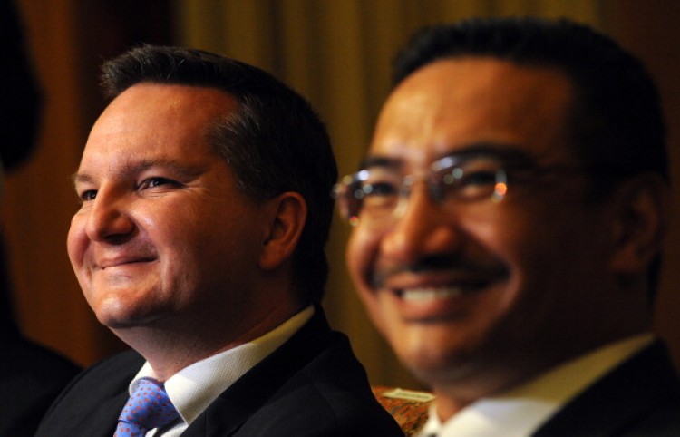 Malaysia's Home Affairs Minister Hishammuddin Hussein (R) and Australian Immigration Minister Chris Bowen smile during a joint press conference after a signing ceremony in Kuala Lumpur on July 25, 2011.  (Saeed Khan/AFP/Getty Images)