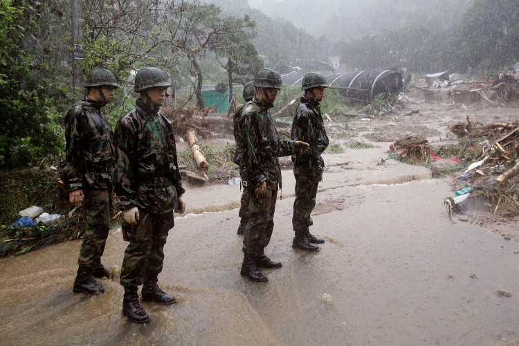 South Korean soldiers begin the clean-up in the aftermath of a torrential rain storm that hit the capital city on July 27, 2011 in Seoul. (Chung Sung-Jun/Getty Images)