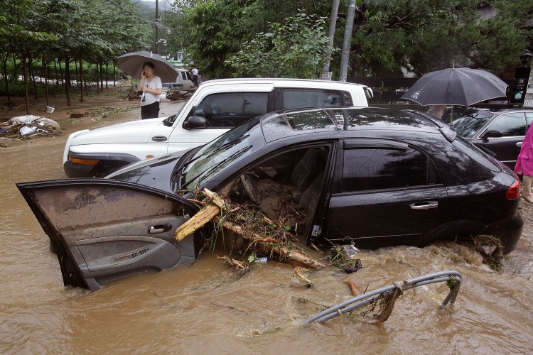 A South Korean woman looks out at the flood water after a torrential rain storm hit the capital city on July 27, 2011 in Seoul. (Chung Sung-Jun/Getty Images)