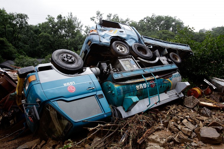 Two vehicles are turned over after a landslide caused by torrential rain storm hit the capital city on July 27, 2011 in Seoul, South Korea. (Chung Sung-Jun/Getty Images)