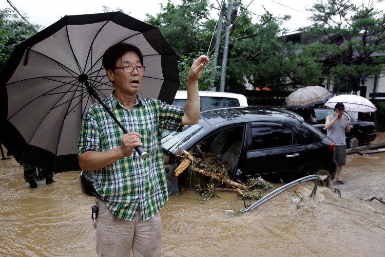 Residents look out at the flood water after a torrential rain storm hit the capital city on July 27, 2011 in Seoul, South Korea. (Chung Sung-Jun/Getty Images)