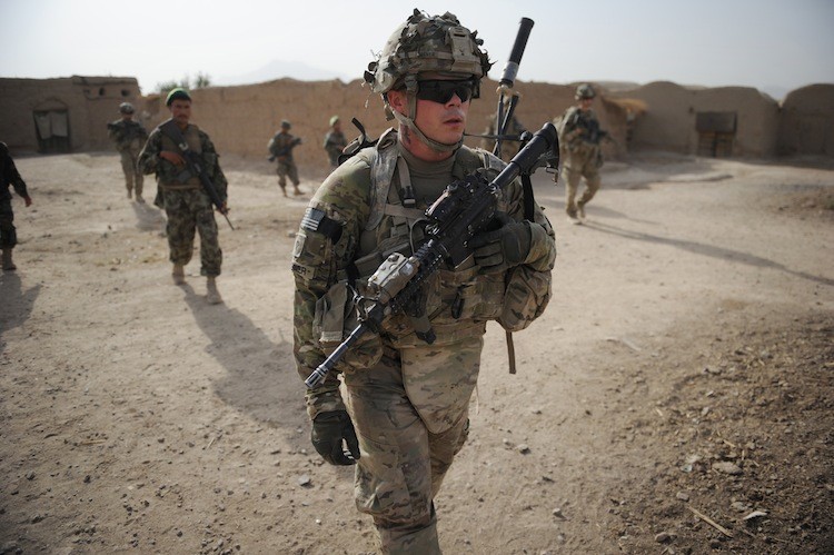 HALF A WORLD AWAY: U.S. soldiers from the Charlie Company, 2-87 Infantry, 3rd Brigade Combat Team conduct patrol at Kandalay village in the southern Afghan province of Kandahar, Afghanistan, on Aug. 8. (Romeo Gacad/Getty Images )