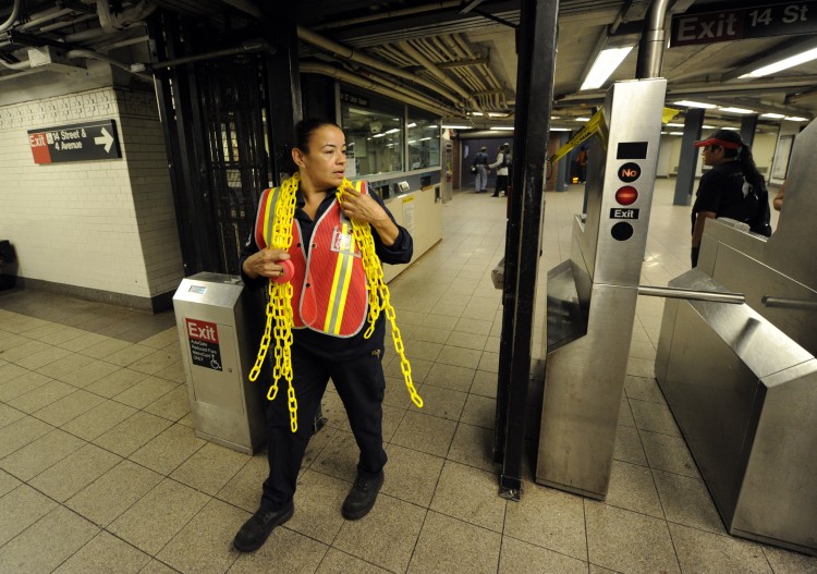 A MTA worker prepares to lock the gates