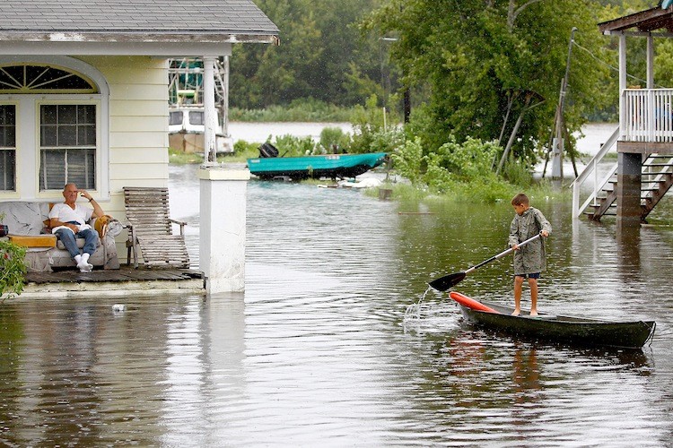 FLOODED IN LOUISIANA: A boy paddles his canoe through flood waters on September 4 in Lafitte, Louisiana. In Louisiana, Texas, and Mississippi, Lee's rains caused flooding.  (Sean Gardner/Getty Images)