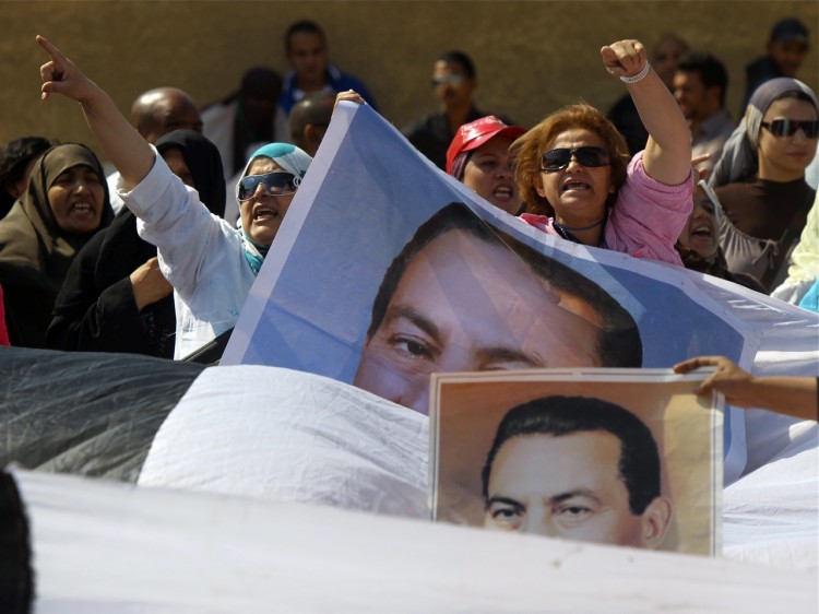 Supporters of Egypt's ousted president Hosni Mubarak (portraits) protest outside the police academy in Cairo where his trial resumed on Sept. 24, 2011.  (Khaled Desouki/AFP/Getty Images)