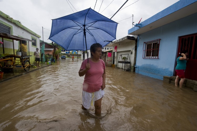 A woman wades through a flooded street, following the passage of Jova Hurricane in the region, in Manzanillo, Colima State, Mexico, on October 12, 2011.  (Alfredo Estrella/AFP/Getty Images)