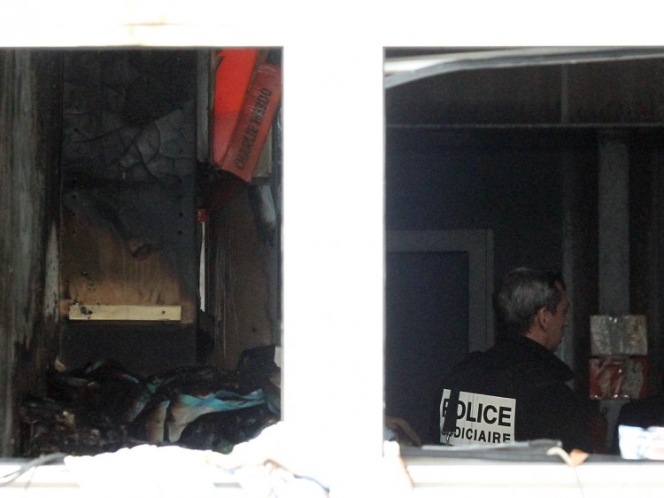 Police inspect the inside of the offices of French satirical magazine 'Charlie Hebdo' following a petrol bomb attack, on Nov. 2, 2011 in Paris, France. (Marc Piasecki/Getty Images)