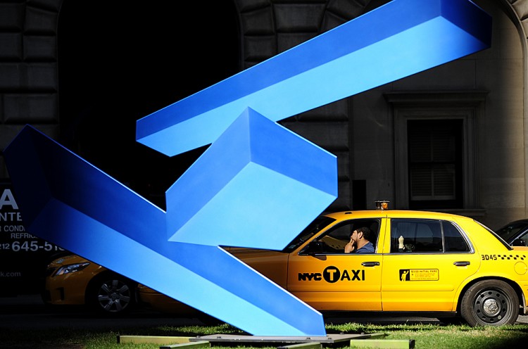 A taxi drives past a modern art sculpture set up Park Avenue, in New York