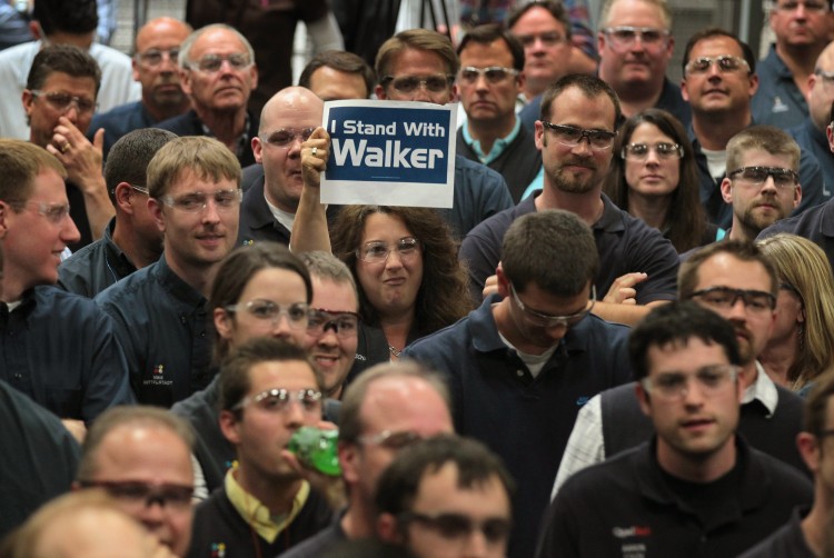 A worker at Quad Graphics shows her support during a campaign stop by Wisconsin Governor Scott Walker on June 1, in Sussex, Wis. Walker will face Democratic contender Milwaukee Mayor Tom Barrett in a recall election on June 5. (Scott Olson/Getty Images) 