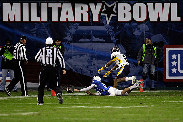 The ball is just out of reach of Air Force kicker Parker Herrington in the Military Bowl in Washington on Wednesday evening. (Rob Carr/Getty Images)