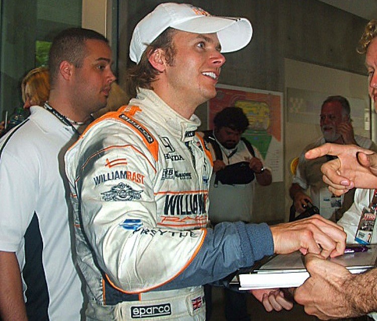 An exuberant Dan Wheldon signs an autograph after winning the Centennial Anniversary Indy 500. (Laura Market/The Epoch Times)