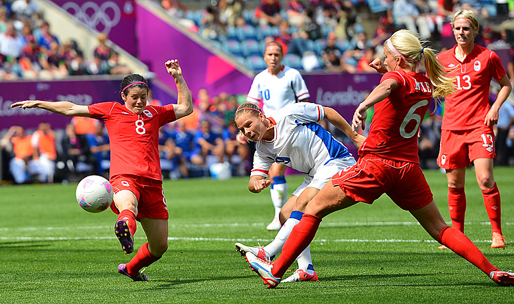 Canadian midfielder Diana Matheson (L) shoots past France's Eugenie Le Sommer (9) during the women's football match for bronze of the London 2012 Olympic Games. (M /Aiguel MedinaFP/GettyImages)