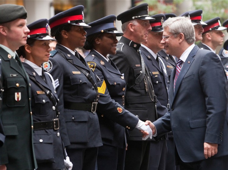 Prime Minister Stephen Harper greets Canadian emergency first responders at a memorial service honouring the victims from the Commonwealth countries who were killed in the 9/11 terrorist attacks (Courtesy Office of the Prime Minister)