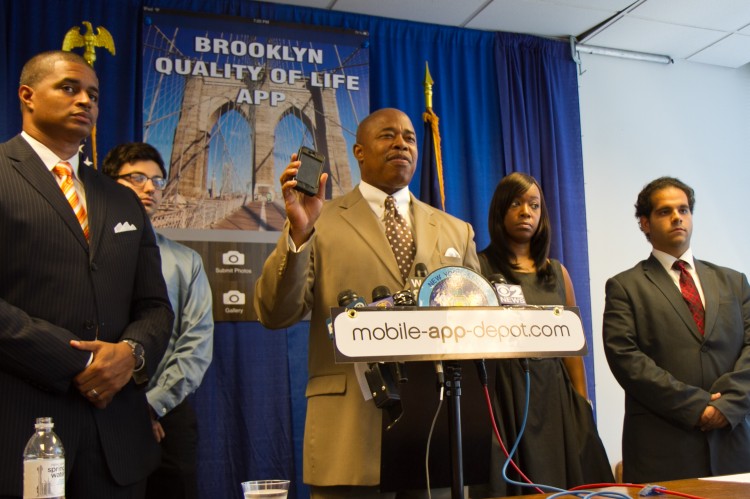 Sen. Eric Adams (C), app designer Garth Naar (L), and assistants in creating the Brooklyn Quality Life App, hold a press conference Sunday in Lower Manhattan. The app helps users send photos and videos of dangerous incidents to government authorities. (Amelia Pang/The Epoch Times)